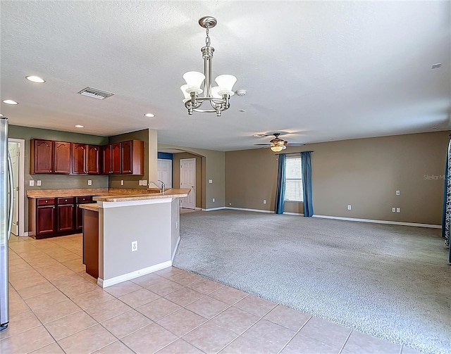 12121 Tree Haven Ave, Gibsonton, FL 33534 - kitchen with a ceiling fan, a chandelier, arched walkways, light countertops, and recessed lighting