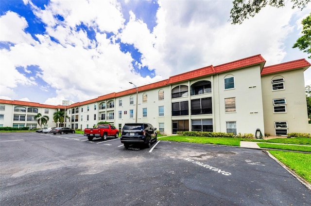 2700 Bayshore Blvd Unit 1206, Dunedin, FL 34698 - view of building exterior featuring uncovered parking