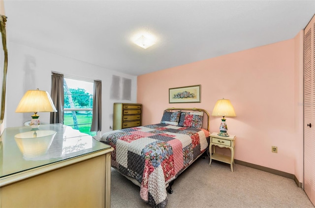 2700 Bayshore Blvd Unit 1206, Dunedin, FL 34698 - bedroom featuring light carpet and a closet