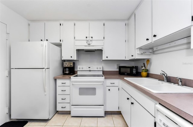 2700 Bayshore Blvd Unit 1206, Dunedin, FL 34698 - kitchen featuring white appliances, premium range hood, white cabinets, and light tile patterned floors