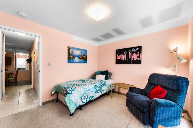 2700 Bayshore Blvd Unit 1206, Dunedin, FL 34698 - carpeted bedroom featuring baseboards and tile patterned flooring