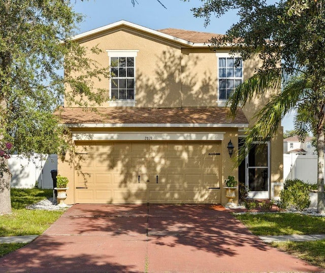 7819 Carriage Pointe Dr, Gibsonton, FL 33534 - traditional-style home with concrete driveway, stucco siding, and a garage