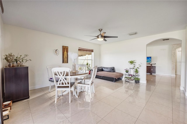 7819 Carriage Pointe Dr, Gibsonton, FL 33534 - dining space with arched walkways, ceiling fan, and light tile patterned flooring