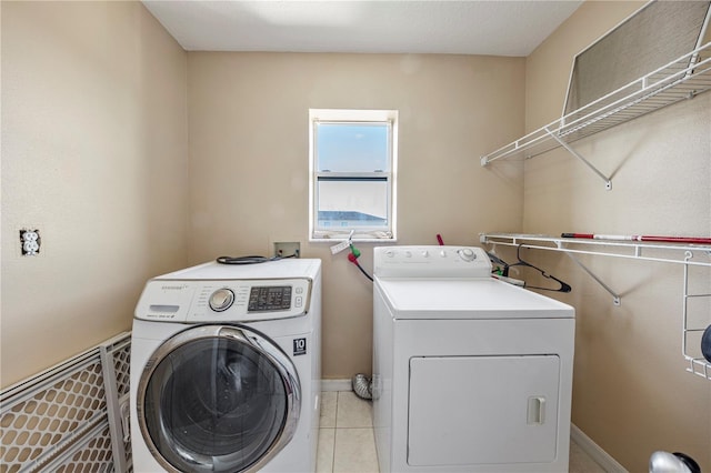 7819 Carriage Pointe Dr, Gibsonton, FL 33534 - laundry area with washing machine and dryer and light tile patterned floors