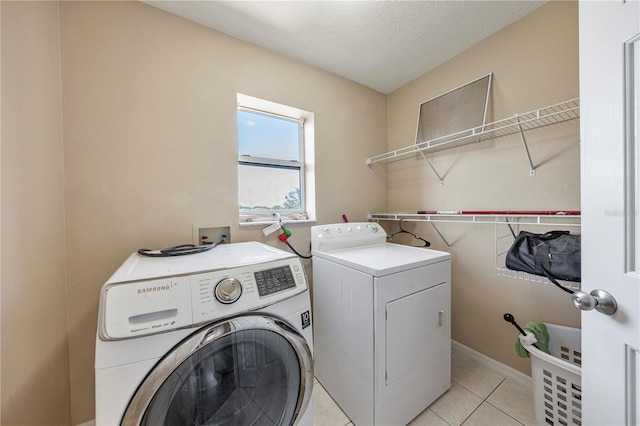 7819 Carriage Pointe Dr, Gibsonton, FL 33534 - laundry room with washing machine and clothes dryer and light tile patterned flooring