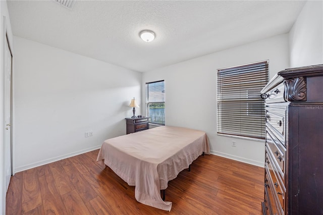 7819 Carriage Pointe Dr, Gibsonton, FL 33534 - bedroom with wood finished floors and a textured ceiling