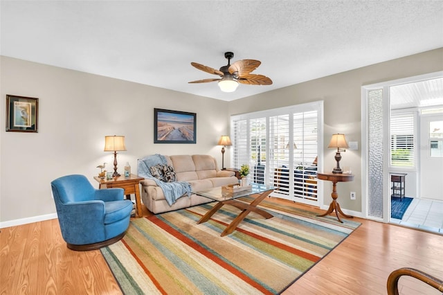 2814 Highlands Blvd Unit B, Palm Harbor, FL 34684 - living area featuring wood finished floors, healthy amount of natural light, and a ceiling fan