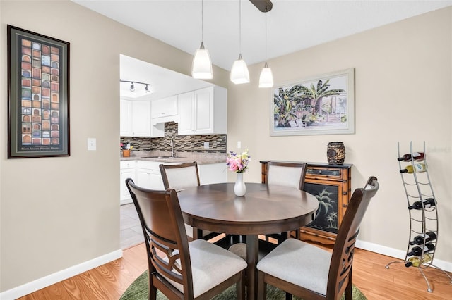 2814 Highlands Blvd Unit B, Palm Harbor, FL 34684 - dining room featuring light wood-type flooring