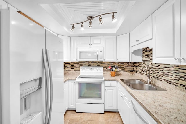 2814 Highlands Blvd Unit B, Palm Harbor, FL 34684 - kitchen with white appliances, a tray ceiling, light countertops, and white cabinetry