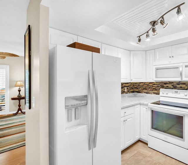 2814 Highlands Blvd Unit B, Palm Harbor, FL 34684 - kitchen featuring white appliances, white cabinets, decorative backsplash, and a raised ceiling