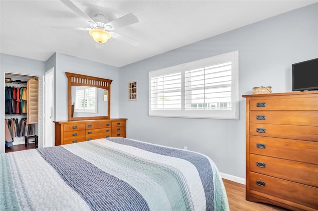 2814 Highlands Blvd Unit B, Palm Harbor, FL 34684 - bedroom featuring light wood finished floors, a closet, ceiling fan, and a spacious closet