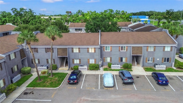 3805 Cortez Cir Unit B, Tampa, FL 33614 - view of property with uncovered parking and stairway