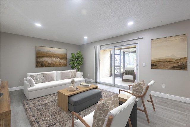 3805 Cortez Cir Unit B, Tampa, FL 33614 - living room featuring recessed lighting, light wood-style floors, and a textured ceiling
