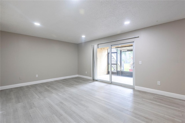 3805 Cortez Cir Unit B, Tampa, FL 33614 - empty room featuring light wood-type flooring, recessed lighting, and a textured ceiling