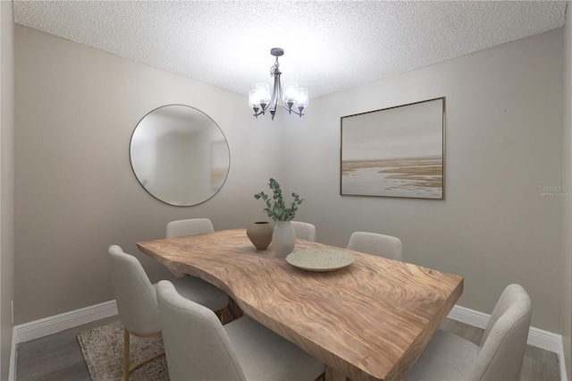 3805 Cortez Cir Unit B, Tampa, FL 33614 - dining space featuring a chandelier, wood finished floors, and a textured ceiling