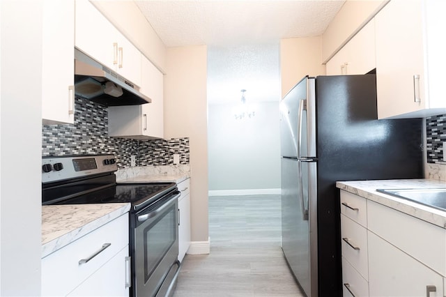3805 Cortez Cir Unit B, Tampa, FL 33614 - kitchen with stainless steel appliances, under cabinet range hood, light countertops, decorative backsplash, and a textured ceiling