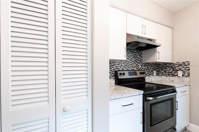 3805 Cortez Cir Unit B, Tampa, FL 33614 - kitchen featuring stainless steel electric range oven, under cabinet range hood, light countertops, decorative backsplash, and white cabinets
