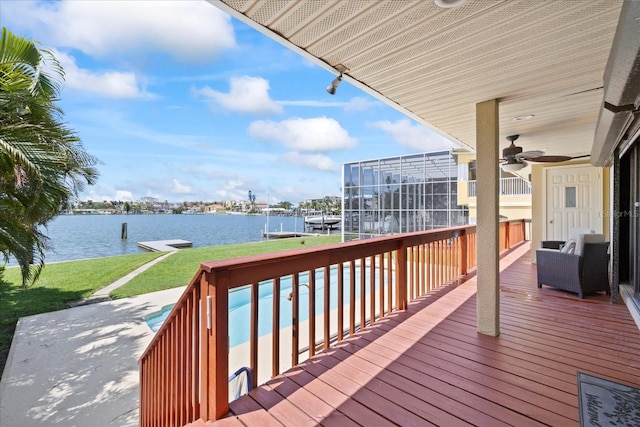 17025 Dolphin Dr, North Redington Beach, FL 33708 - deck featuring a water view, a boat dock, a lawn, a ceiling fan, and boat lift