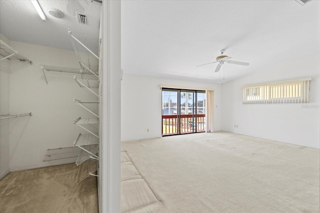 17025 Dolphin Dr, North Redington Beach, FL 33708 - walk in closet featuring carpet floors and a ceiling fan