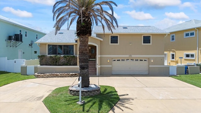 17025 Dolphin Dr, North Redington Beach, FL 33708 - view of front of house featuring stucco siding, driveway, an attached garage, and roof with shingles