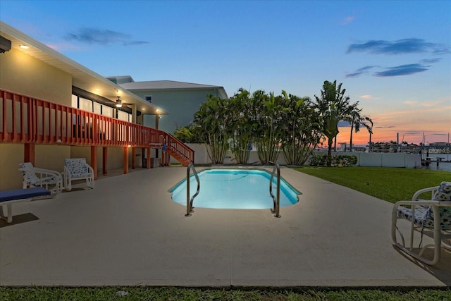 17025 Dolphin Dr, North Redington Beach, FL 33708 - pool at dusk featuring stairway, a patio area, and a deck