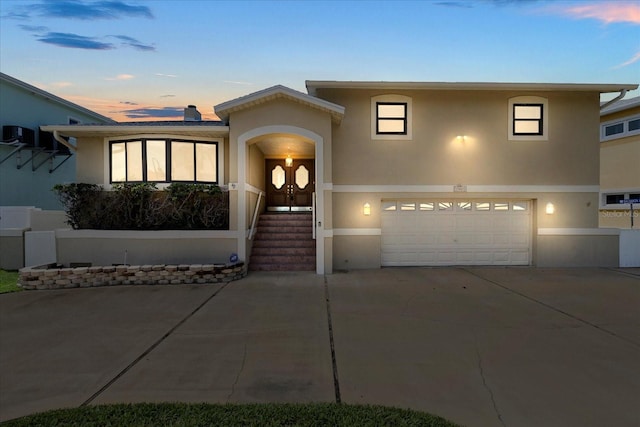 17025 Dolphin Dr, North Redington Beach, FL 33708 - view of front facade with stucco siding, driveway, and a garage