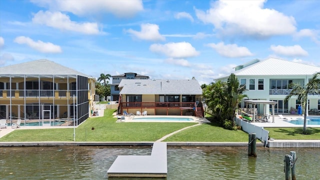 17025 Dolphin Dr, North Redington Beach, FL 33708 - dock with an outdoor pool, a water view, a patio area, and a yard