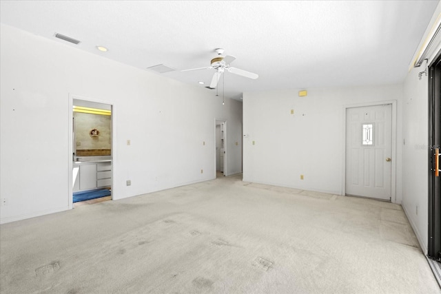 17025 Dolphin Dr, North Redington Beach, FL 33708 - unfurnished living room with light colored carpet and ceiling fan