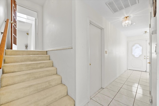 17025 Dolphin Dr, North Redington Beach, FL 33708 - foyer entrance with stairs and light tile patterned flooring