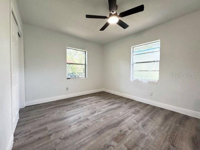 1400 E Fern Rd, Lakeland, FL 33801 - unfurnished bedroom with multiple windows, wood finished floors, a closet, and a ceiling fan