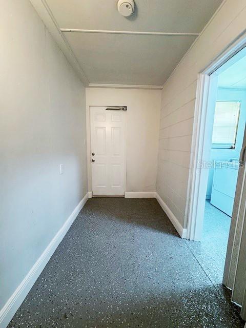 1400 E Fern Rd, Lakeland, FL 33801 - corridor featuring baseboards and speckled floor