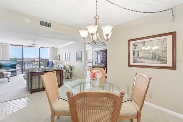 1 Key Capri Unit 302E, Treasure Island, FL 33706 - dining room featuring light carpet, a chandelier, and a ceiling fan