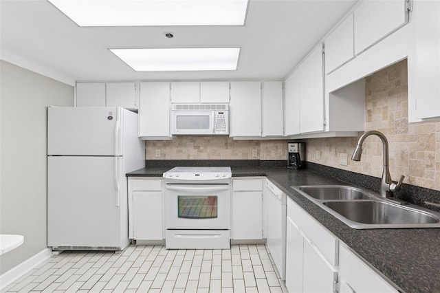 1 Key Capri Unit 302E, Treasure Island, FL 33706 - kitchen featuring white appliances, decorative backsplash, white cabinets, and dark countertops