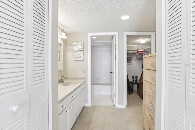 1 Key Capri Unit 302E, Treasure Island, FL 33706 - full bathroom with a closet, a textured ceiling, vanity, and recessed lighting
