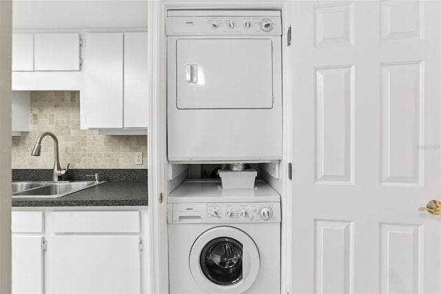 1 Key Capri Unit 302E, Treasure Island, FL 33706 - laundry room with stacked washer / dryer