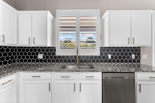 1291 Blackrush Dr, Tarpon Springs, FL 34689 - kitchen with dishwasher, white cabinets, dark stone counters, and decorative backsplash