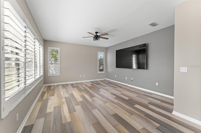 1291 Blackrush Dr, Tarpon Springs, FL 34689 - unfurnished room featuring light wood finished floors and a ceiling fan
