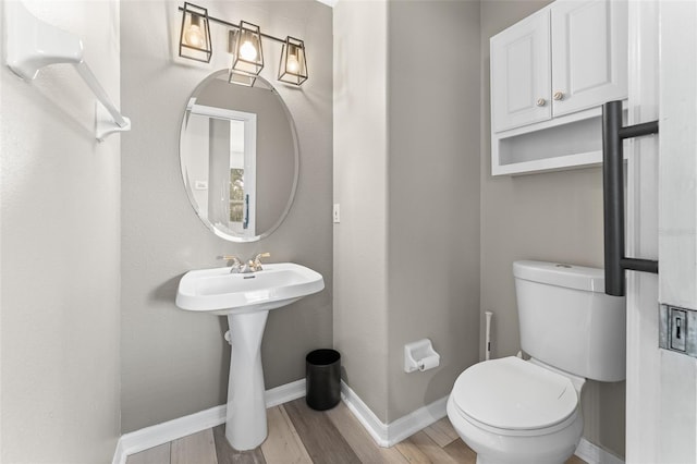 1291 Blackrush Dr, Tarpon Springs, FL 34689 - half bathroom featuring wood finished floors and toilet