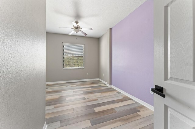1291 Blackrush Dr, Tarpon Springs, FL 34689 - empty room featuring ceiling fan, wood finished floors, and a textured wall