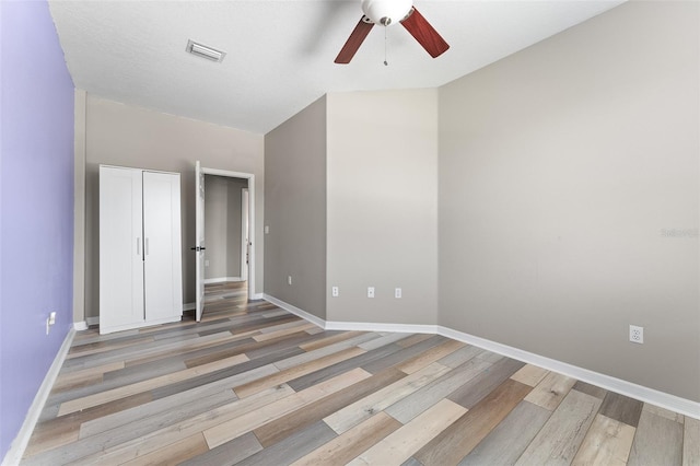 1291 Blackrush Dr, Tarpon Springs, FL 34689 - unfurnished bedroom with wood finished floors and a ceiling fan