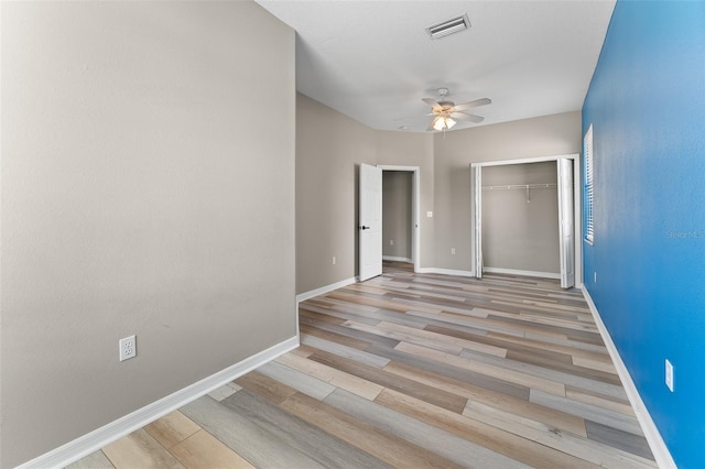 1291 Blackrush Dr, Tarpon Springs, FL 34689 - unfurnished bedroom with wood finished floors, a closet, and a ceiling fan
