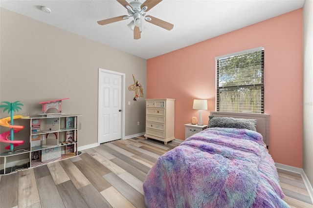 1291 Blackrush Dr, Tarpon Springs, FL 34689 - bedroom with wood finished floors and a ceiling fan