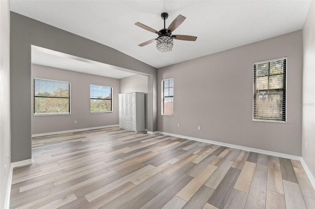 1291 Blackrush Dr, Tarpon Springs, FL 34689 - unfurnished room featuring light wood-type flooring, ceiling fan, and vaulted ceiling
