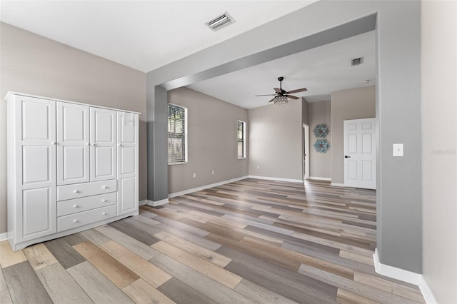 1291 Blackrush Dr, Tarpon Springs, FL 34689 - unfurnished living room featuring light wood-style floors and ceiling fan