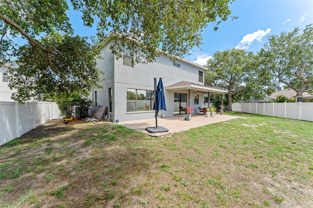 1291 Blackrush Dr, Tarpon Springs, FL 34689 - rear view of property with a patio area, a fenced backyard, a ceiling fan, and stucco siding