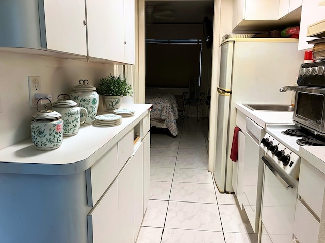 1865 Mazo Mnr Unit 1, Lutz, FL 33558 - kitchen featuring light marble finish flooring, light countertops, white cabinetry, and stove