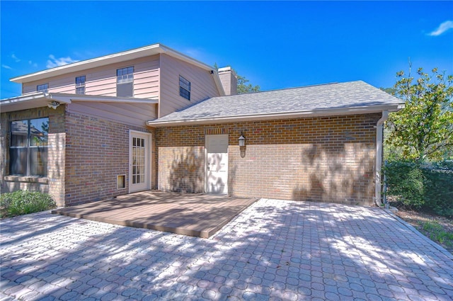 3125 S Miller Rd, Valrico, FL 33596 - view of side of home with brick siding, a patio area, and a chimney