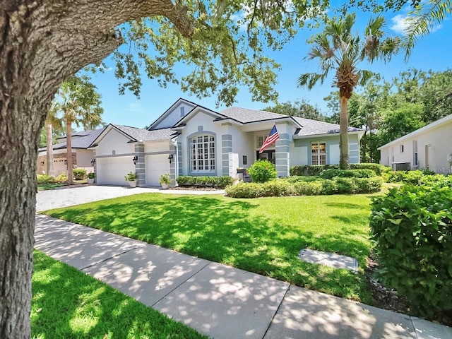 3506 Cordgrass Dr, Valrico, FL 33596 - ranch-style house with stucco siding, a front lawn, a garage, and driveway