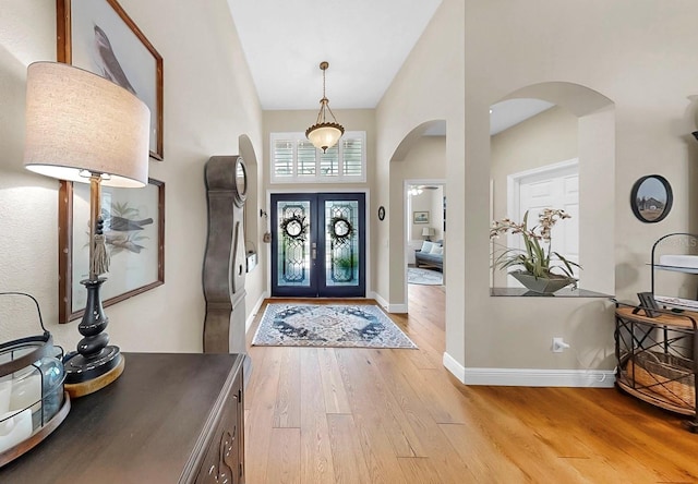 3506 Cordgrass Dr, Valrico, FL 33596 - foyer entrance featuring arched walkways, light wood finished floors, and french doors