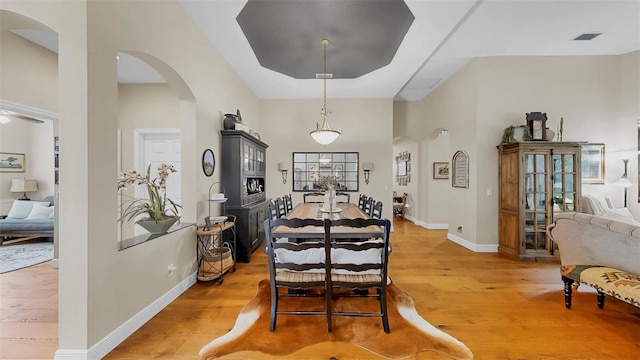 3506 Cordgrass Dr, Valrico, FL 33596 - dining space featuring arched walkways, light wood-style flooring, and a high ceiling